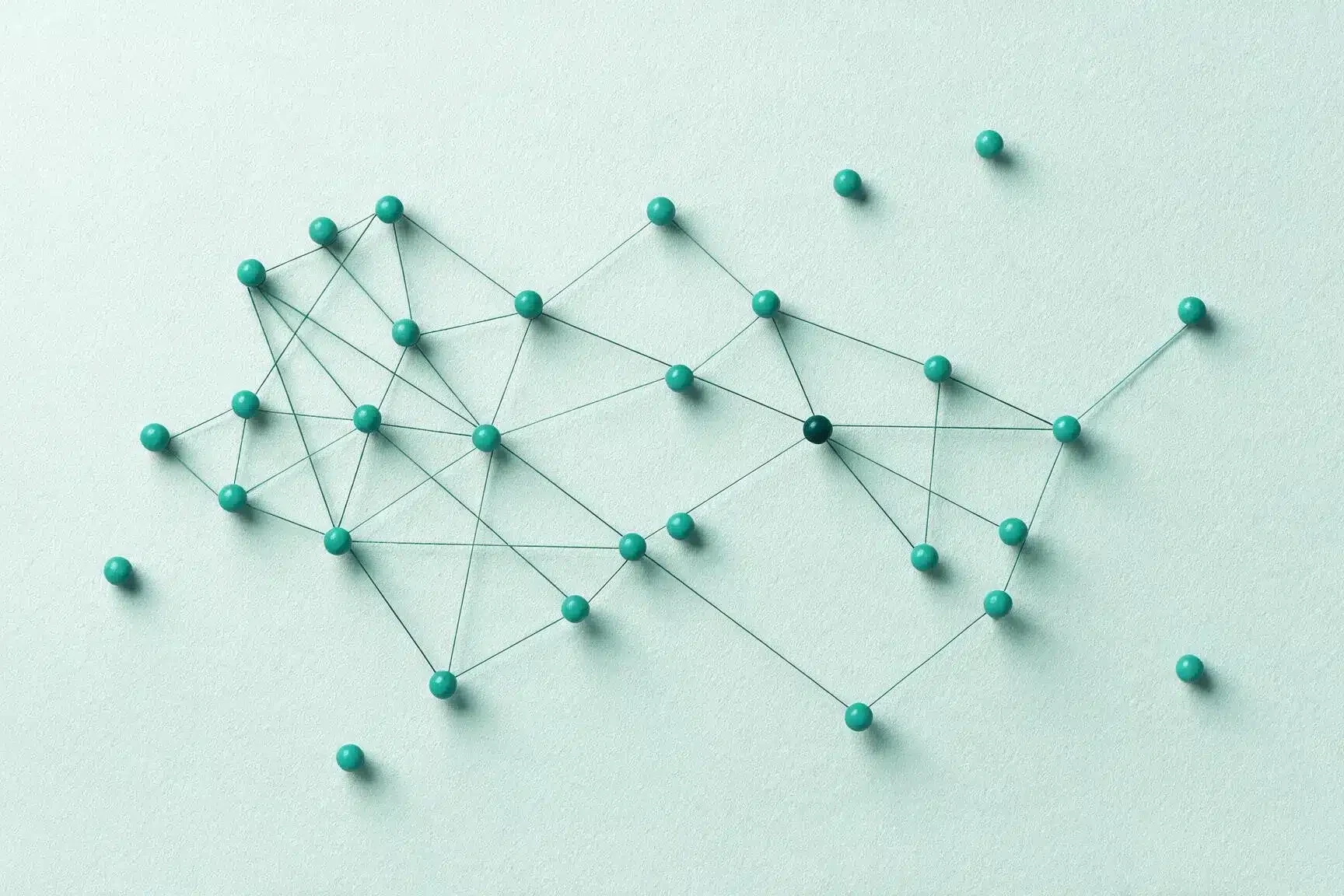Abstract network of teal pushpins connected by black strings on a pale teal background.